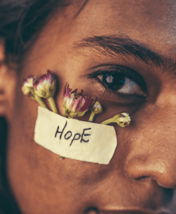Young South Asian woman with a bandage reading "Hope," symbolizing self-compassion and healing in the South Asian community